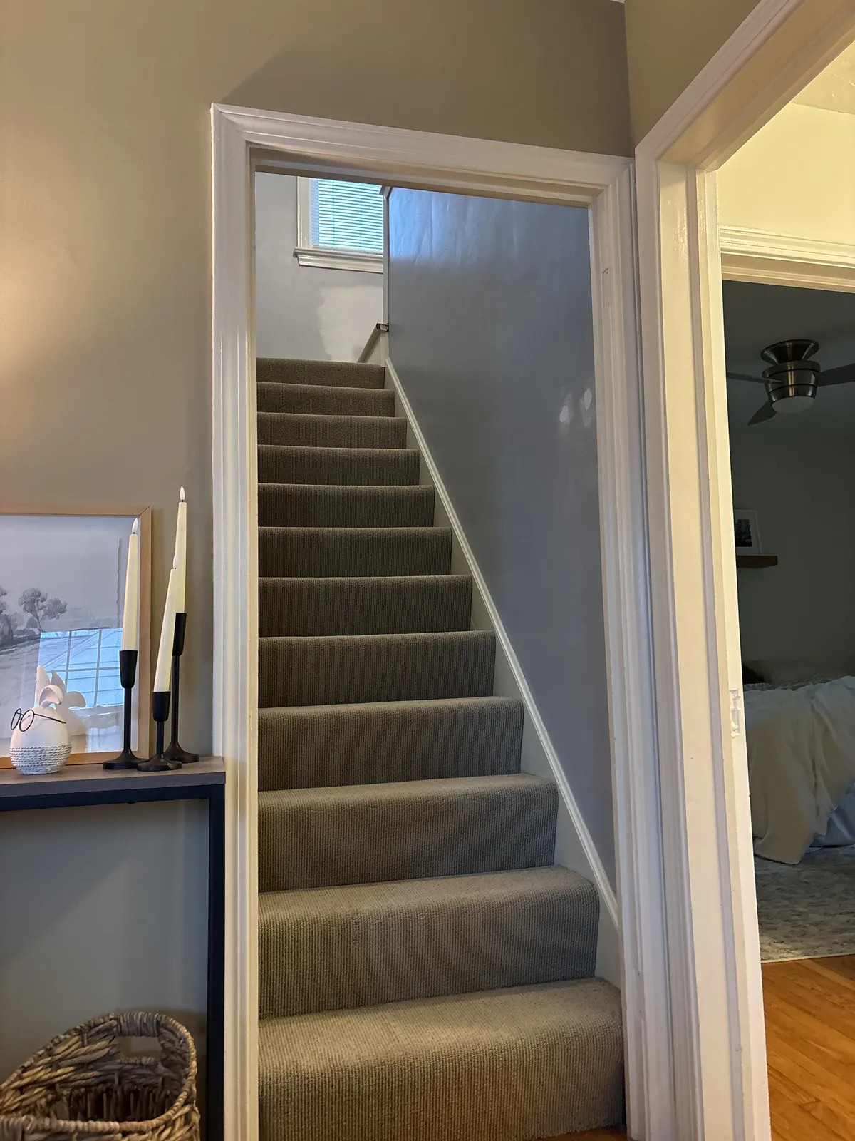 Narrow staircase with carpeted treads before renovation